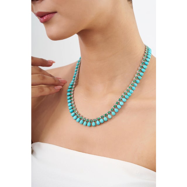 This statement necklace features 47.9 carats of pear-cut cabochon turquoise and emeralds, set in 14k white gold. Each...