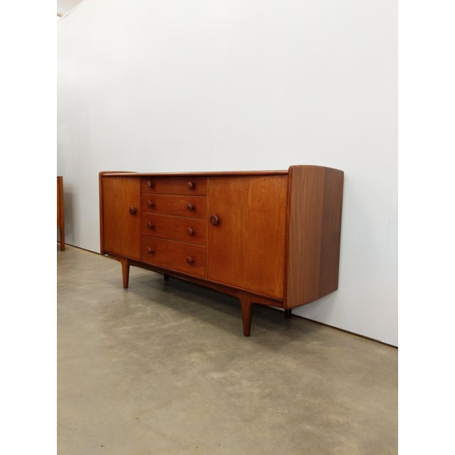 Authentic vintage mid century modern teak credenza / sideboard / console. Designed by John Herbert for A. Younger Ltd....