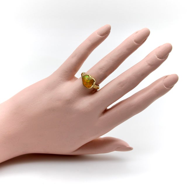 This 18k gold hand hammered ring features a glowing fire opal in an organic shape. This one-of-a-kind ring was handmade in...