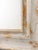 A beautifully handcrafted oversized wall mirror featuring an elegant distressed white finish enhanced with warm antique...