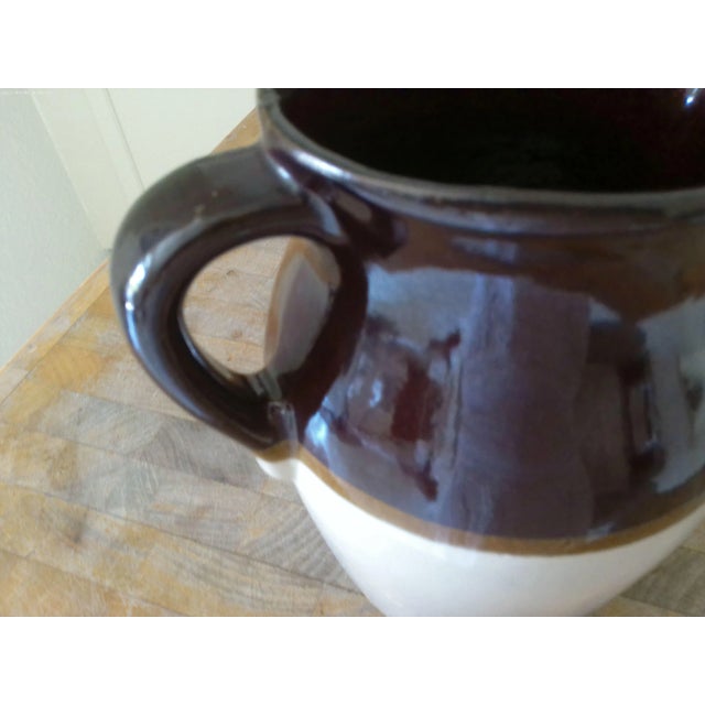 Large mid-century stoneware glazed pitcher hand-dipped in shades of cream, light and dark brown. Perfect for serving...