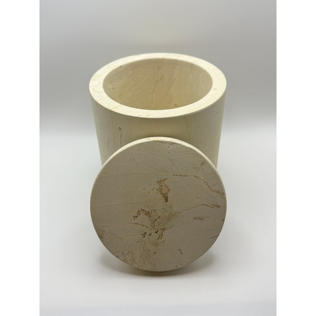 Beautiful solid travertine canister handcrafted from natural stone with a clean cylindrical silhouette and fitted lid. The...
