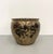 An elegant vintage Chinoiserie cachepot featuring a rounded silhouette with richly detailed black and antique gold...