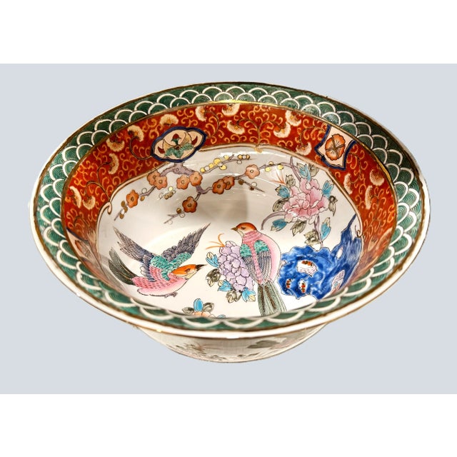 A gorgeous, hand painted Chinese bowl from the mid 20th century with vibrant colors, birds in pinks, greens and orange....