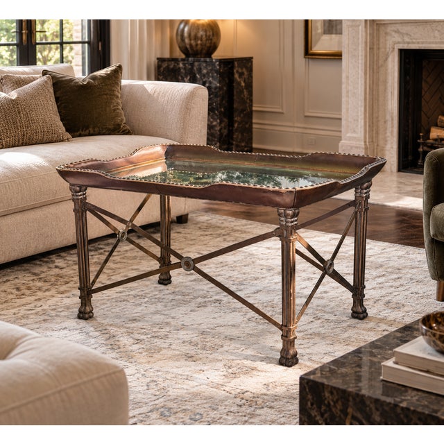 A distinctive leather, iron and glass occasional table attributed to Maitland-Smith, dating to the 2000s. The design...