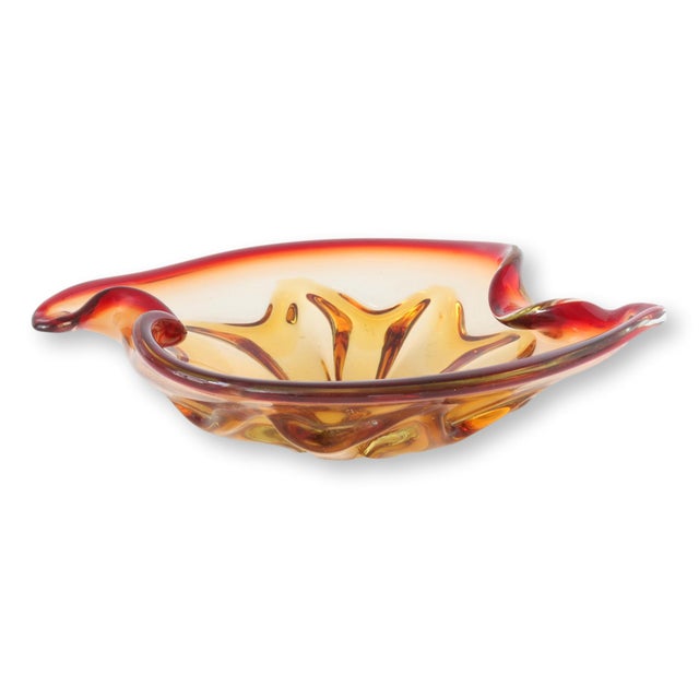 Traditional midcentury Italian Murano glass bowl, hand-blown into a stunning display of fiery ambers and reds. Each swirl...