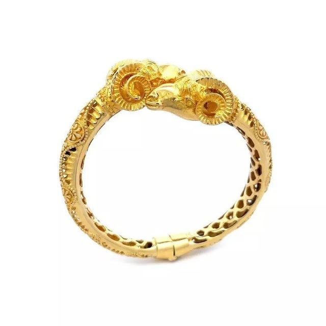 This gorgeous 18k yellow gold bracelet features a pair of artfully rendered ram's heads nuzzle up to each other in this...