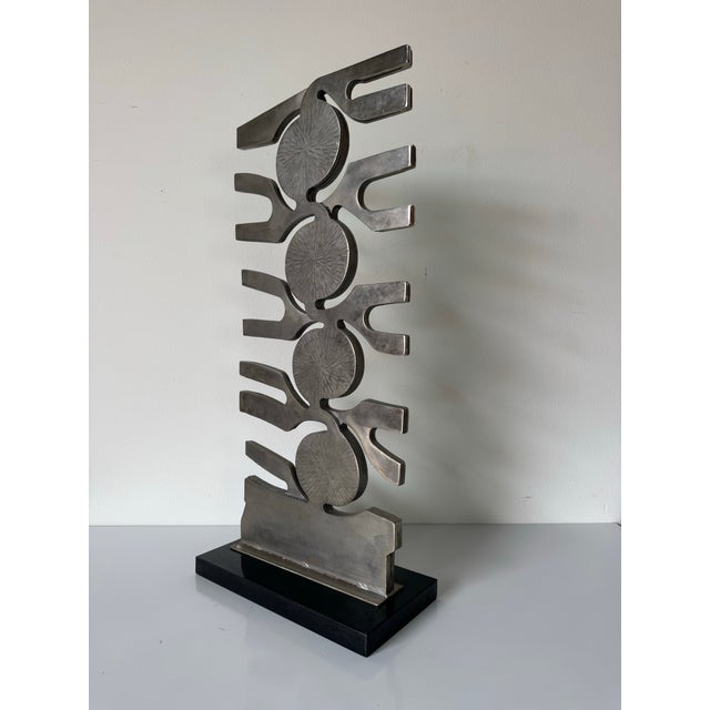 Striking vintage Brutalist abstract sculpture crafted in stainless steel. C, 1980s. The composition features a bold...