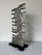 Striking vintage Brutalist abstract sculpture crafted in stainless steel. C, 1980s. The composition features a bold...