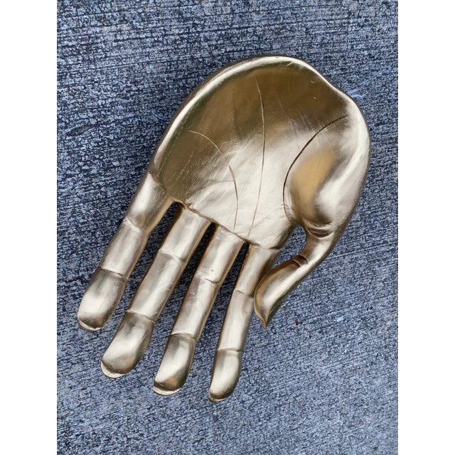 Large gilded hand bowl is perfect to display or as a catchall or collection of fruit. Made of wood. In good condition