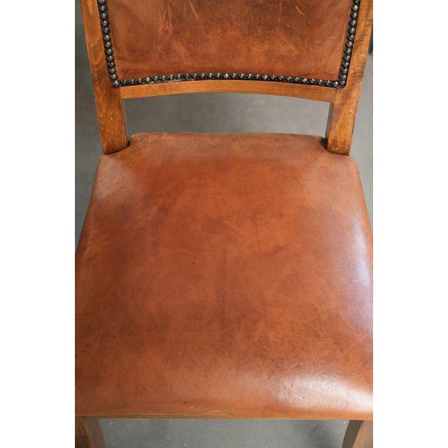 This characterful set of 8 sheepskin dining chairs features a beautiful patina and is finished with decorative nails. The...