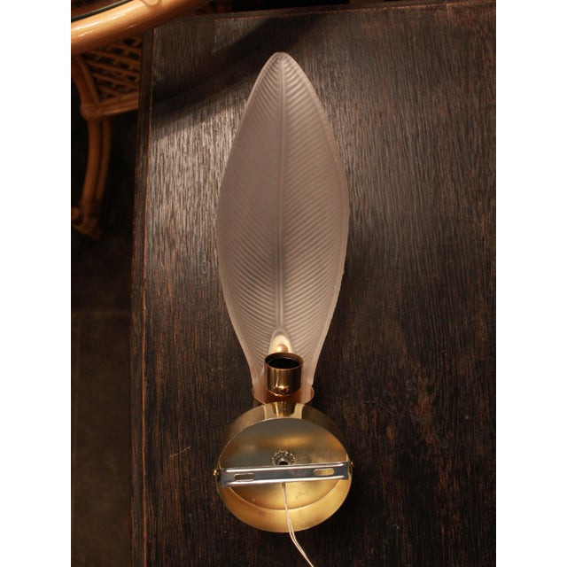 Italian wall sconce dating from the mid-20th century, featuring a handcrafted Murano glass leaf with sculpted vein...