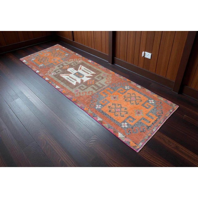 Elevate your space with this authentic vintage Turkish runner rug, expertly handwoven in the heart of Anatolia. Measuring...