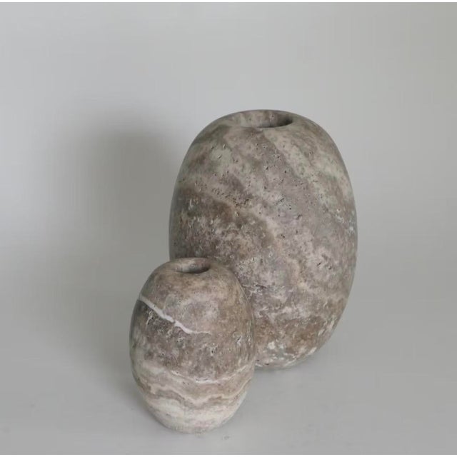 The Dado M by Michael Verheyden is crafted from Travertine Grey, showcasing natural stone patterns in soft, earthy tones....