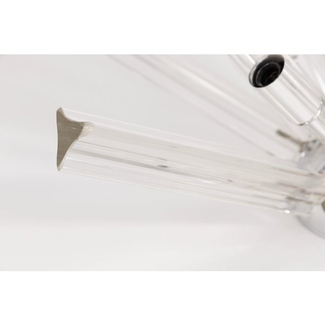 This striking Mid Century Modernist ceiling light features an array of hand-blown Murano glass rods radiating from a...