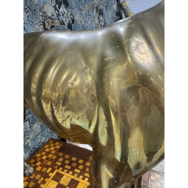 Striking large-scale vintage brass sculpture depicting an elegant standing greyhound. Beautifully modeled with the breed’s...