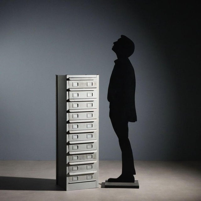 Vintage metal filing cabinet with ten drawers. This piece is attributed to the mentioned designer/maker. It has no...