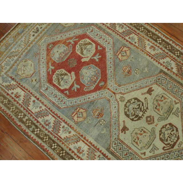Early 20th century Persian Malayer rug in soft blue, brown, and apricot tones Measures: 3'2'' x 12'.