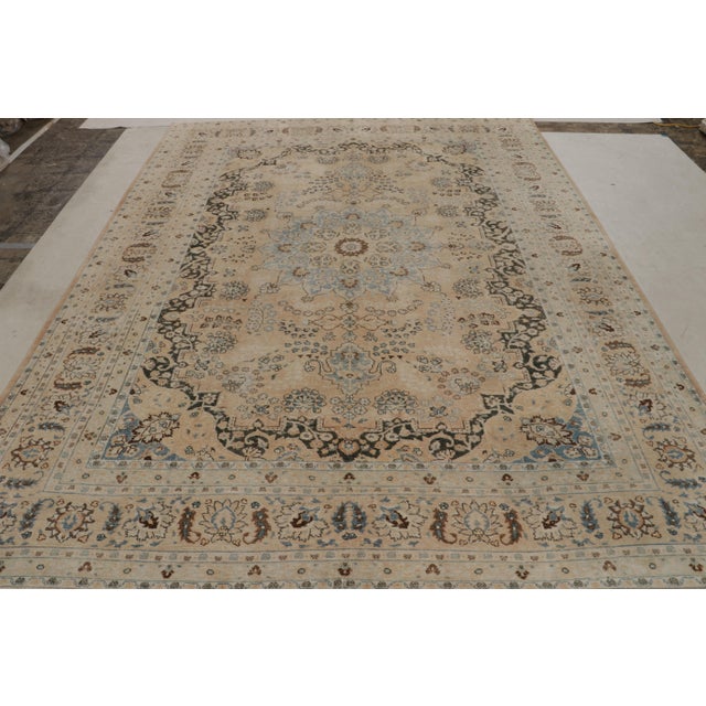 Handwoven in wool, this 8x11 antique Persian Yazd rug originating circa 1920-1930, with intricate rosette medallion and...