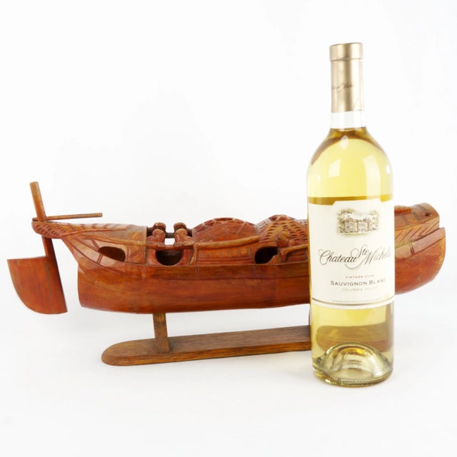 A large and detailed bamboo carving of a Chinese junk. A large segment of bamboo has been hand carved into the shape of a...