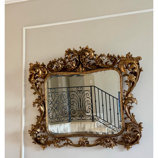 Exceptional antique Italian Florentine giltwood mirror, hand-carved in the Baroque Revival / Rococo style typical of late...