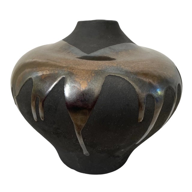 Add a touch of vintage elegance to your home decor with this beautiful Haeger black volcanic lava glaze pottery vase. Made...