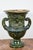 A large pair of relief molded, period, hand-sculpted terracotta urns in lush green glaze. Each piece features two,...