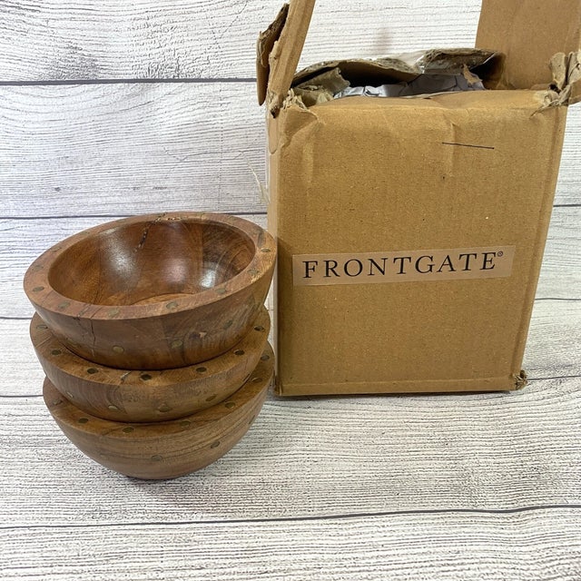 Add refined, rustic character to your tablescape with this set of three Teigen wood and rivet snact bowls. Made of acacia...