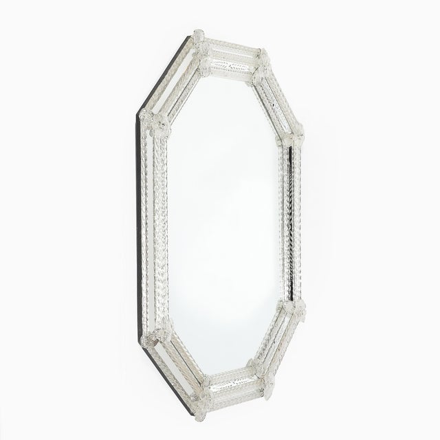 This Mid-Century Modernist Venetian mirror, crafted in Italy circa 1950, is a striking example of Venetian glass artistry....