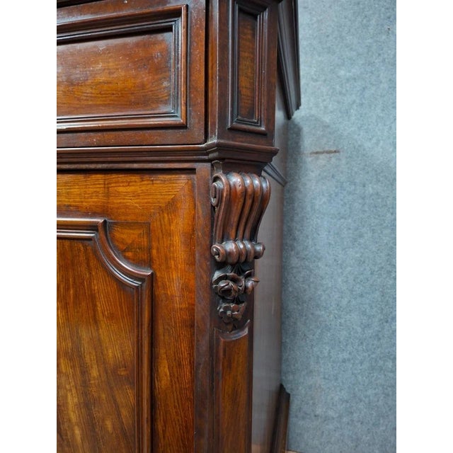 A drop-front writing desk, crafted from solid wood and veneer, with two doors at the front and a drop-front revealing a...