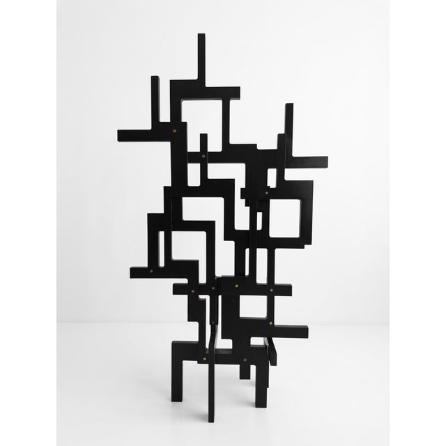 A unique abstract sculpture of French origin, dating to the 1990s. The work consists of an intricate network of black-...