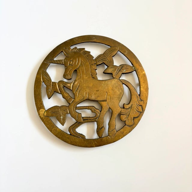 A beautiful circular brass trivet with the design of a unicorn. Perfect for keeping hot plates off of surfaces.