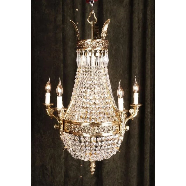 Basket chandelier in BiedermeierClassicist style. Engraved bronze. Basket formed corpus. Adorned with classicist basket-...