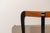 Art Deco style side table in walnut and ebonized wood. The tabletop is rectangular and features a thinner lower shelf that...