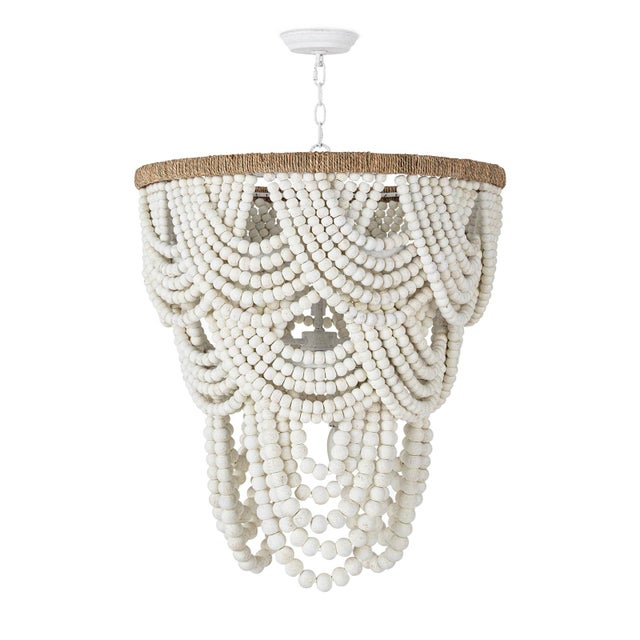 Cascading layers of soft-distressed white wooden beads in the Lorelei Chandelier provide a graceful display over a jute-...