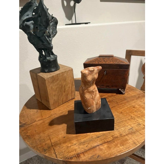 Handsome abstract female marble torso sculpture. The artist is unknown. The 6.25” high marble torso sitting on a black...