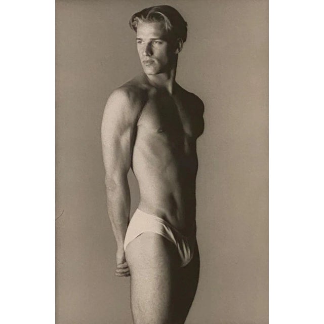 A Vintage black and white photograph of a young fit man, circa 1970