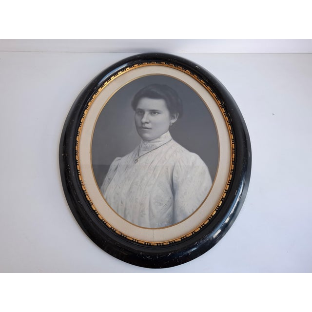 An elegant antique portrait of a young woman from the early 20th century, circa 1900, originating from Czechoslovakia. The...