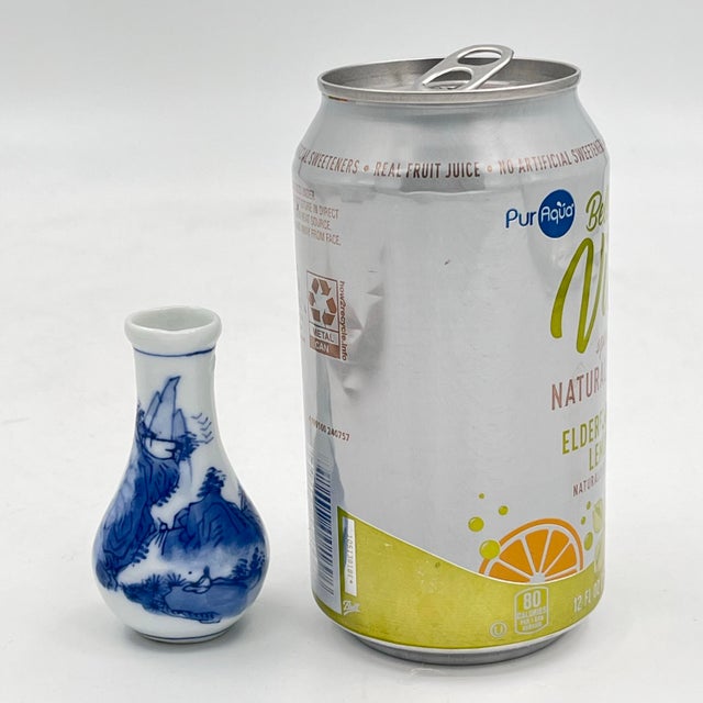 Adorable vintage petite blue and white chinoiserie bud vase featuring a classic underglaze landscape design. This...