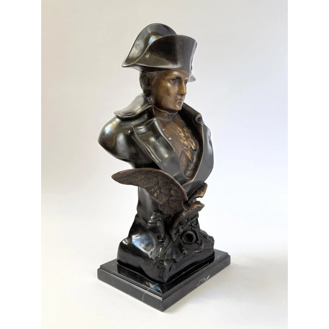 Finely cast bronze bust of Napoleon Bonaparte wearing his iconic bicorne hat, modeled with expressive detail and mounted...