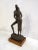 Tabletop sculpture of two stylized figures atop a wooden base. This piece dated 1965 is by Austin Productions. WEAR Minor...