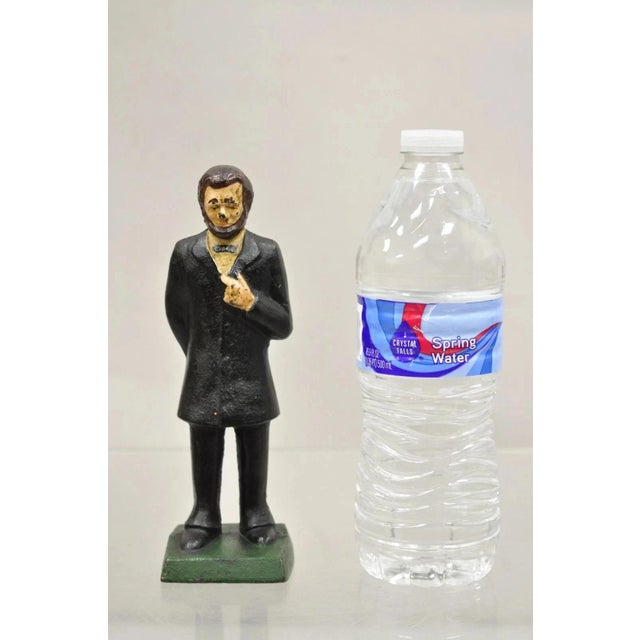 Antique Victorian Cast Iron Honest Abe Abraham Lincoln Figural Painted Door Stop. Circa Early 20th Century. Measurements:...