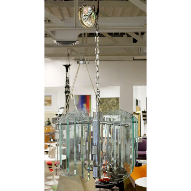 For your consideration is a majestic looking, multi layered glass and chrome chandelier by Luminaire. In good vintage...