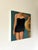 A black suit and a straw sunhat. Because of the cropped scene, viewers get a sense of the image without being told who the...