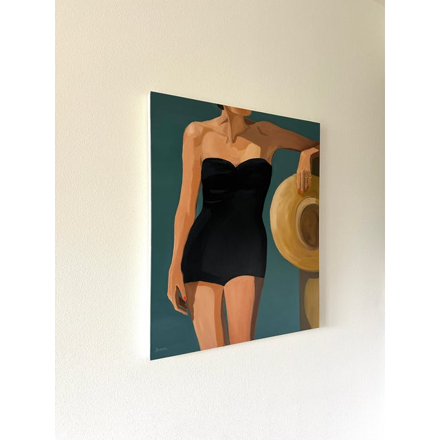 A black suit and a straw sunhat. Because of the cropped scene, viewers get a sense of the image without being told who the...