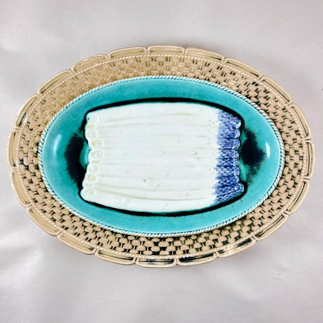 From the Orchies Faïencerie in Saint-Armand-Les-Eaux, Northern France, a majolica glazed oval asparagus server, circa...