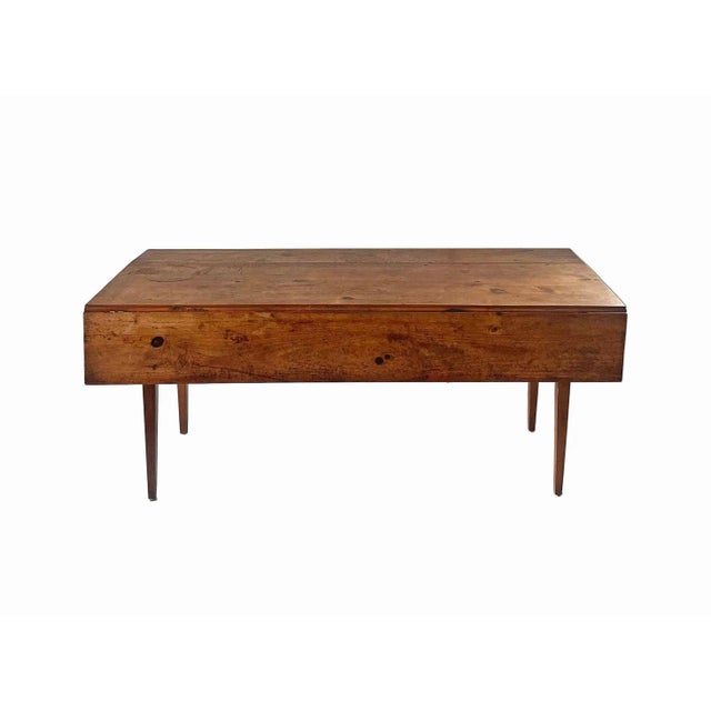 Vintage, drop leaf harvest table made by Townshend, Vermont. Easily stores as a console or side table. There are three...