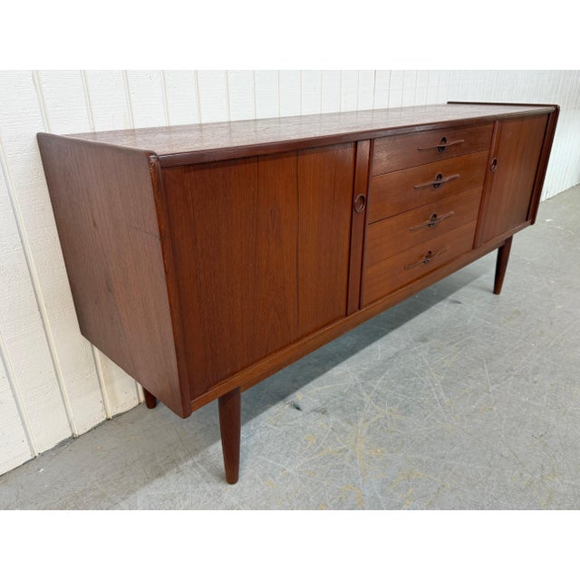 This listing is for a Mid-Century Danish Modern Teak Tambour Sideboard. Featuring a straight line design, rolling tambour...