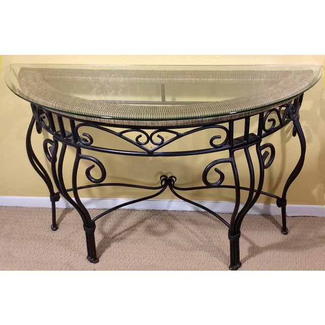 A beautiful iron console table with beveled glass and woven rattan top. This fine table is in excellent condition and...