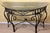 A beautiful iron console table with beveled glass and woven rattan top. This fine table is in excellent condition and...